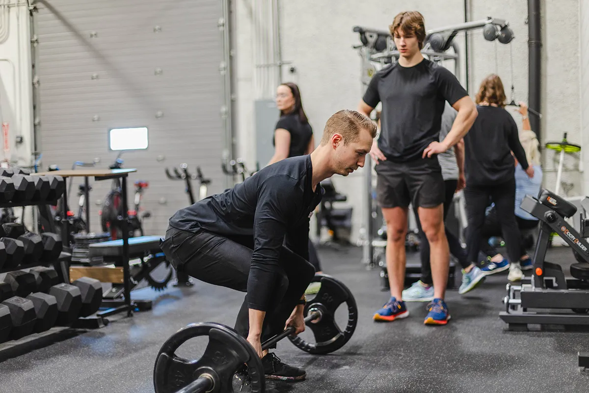 Kyle Krabben Demonstrates Deadlift to Athlete at Zenith Human Performance